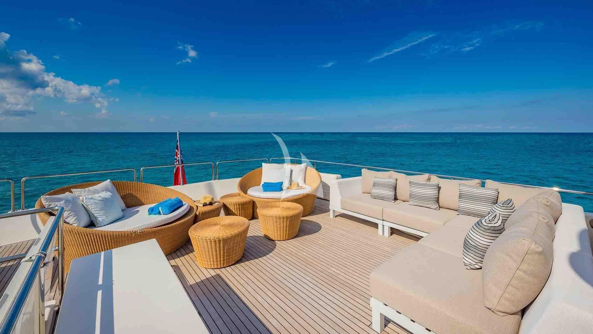 a room with a view of the ocean and a beach aboard ONE AND ONLY Yacht for Sale
