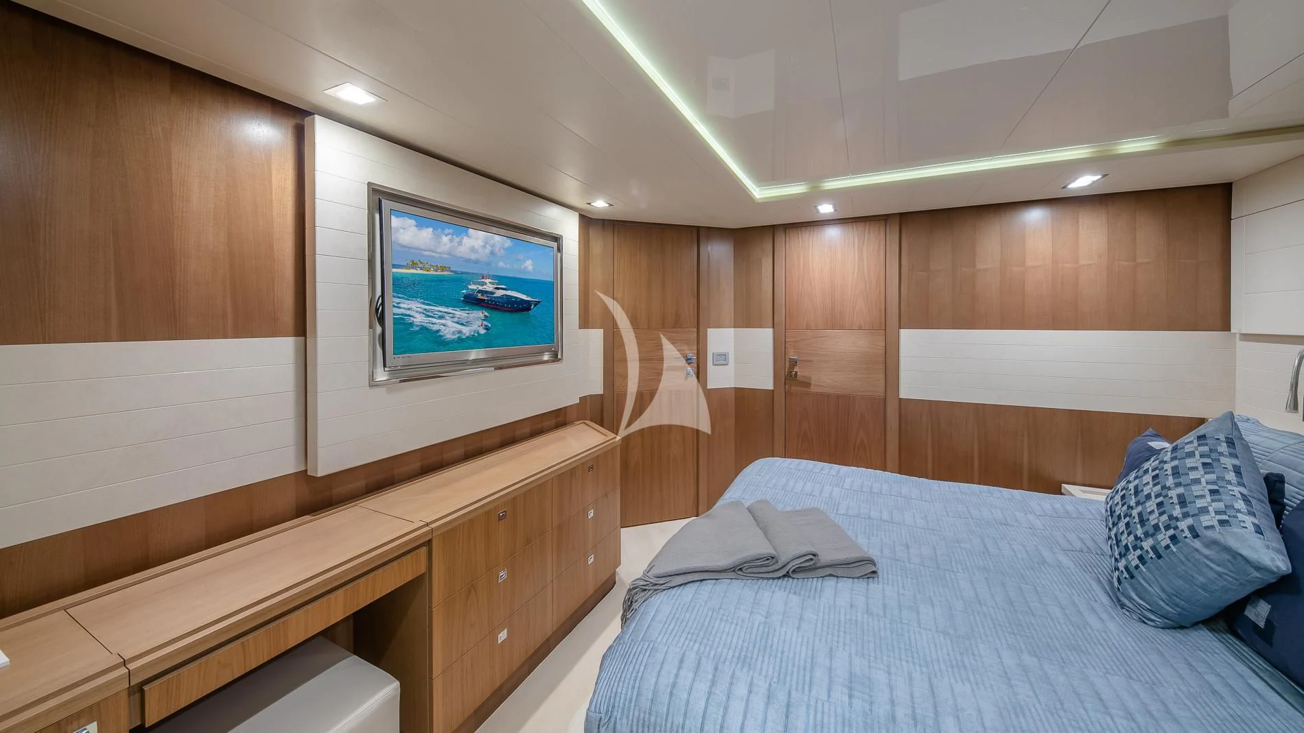a room with a bed and a tv on the wall aboard ONE AND ONLY Yacht for Sale