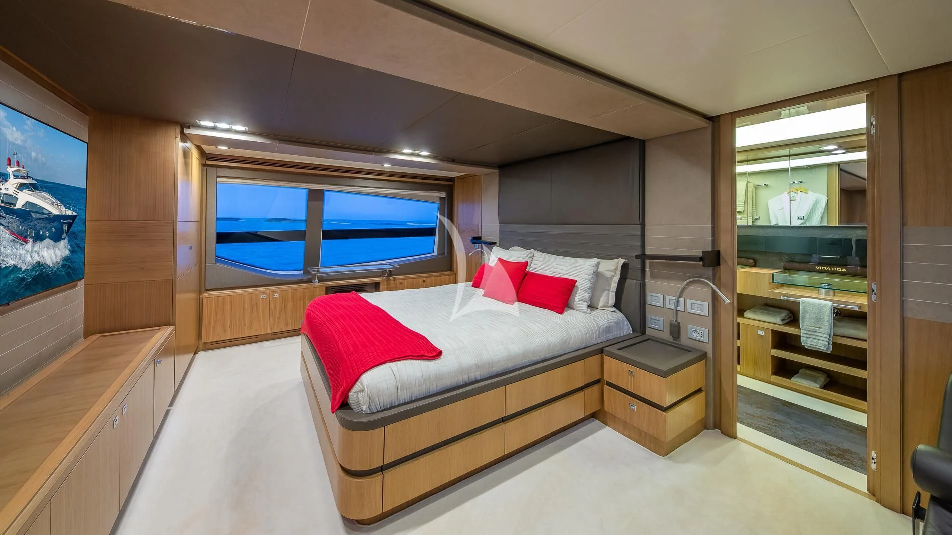 a bedroom with a bed and a desk aboard ONE AND ONLY Yacht for Sale