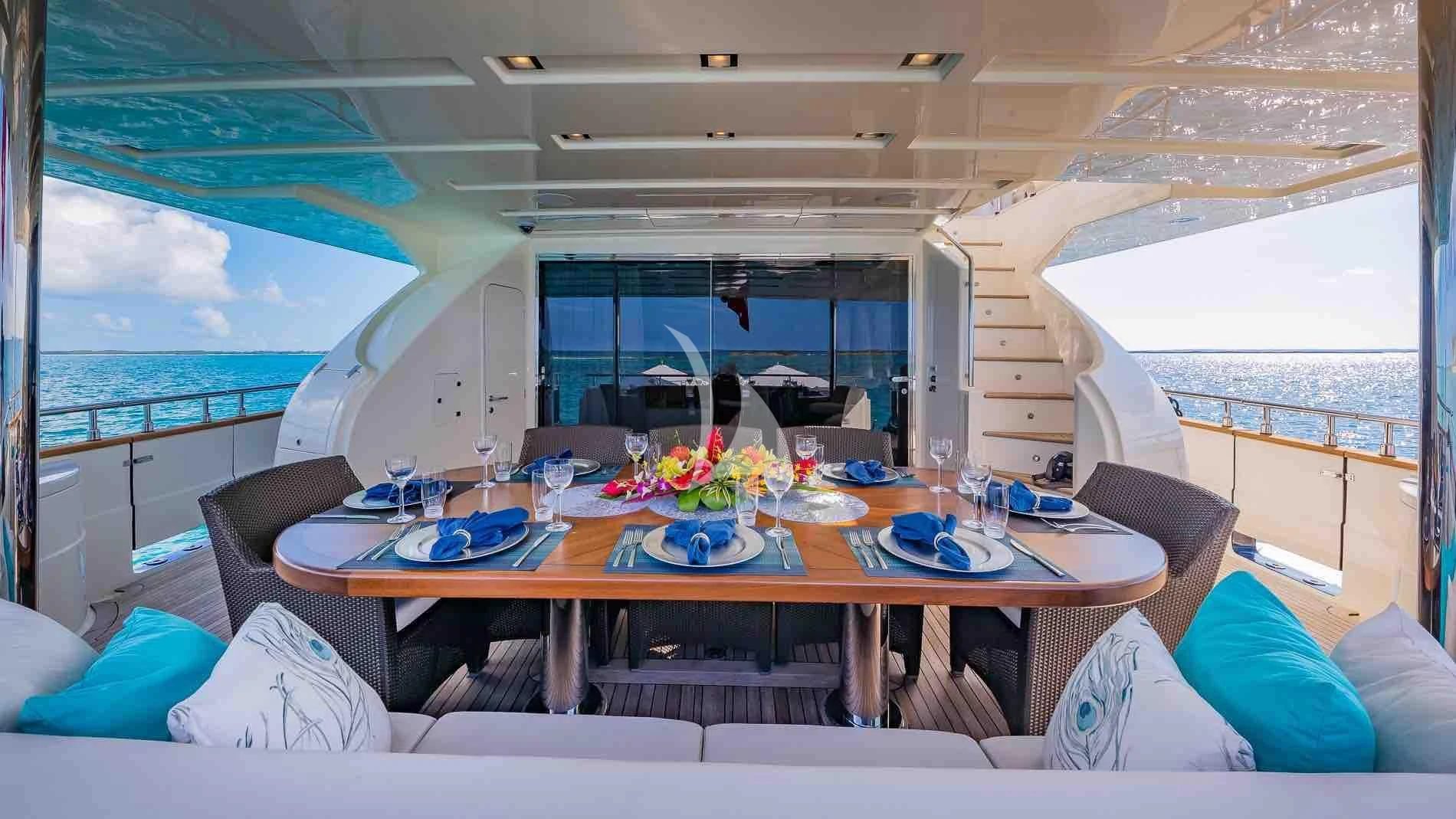 a dining table in a room aboard ONE AND ONLY Yacht for Sale
