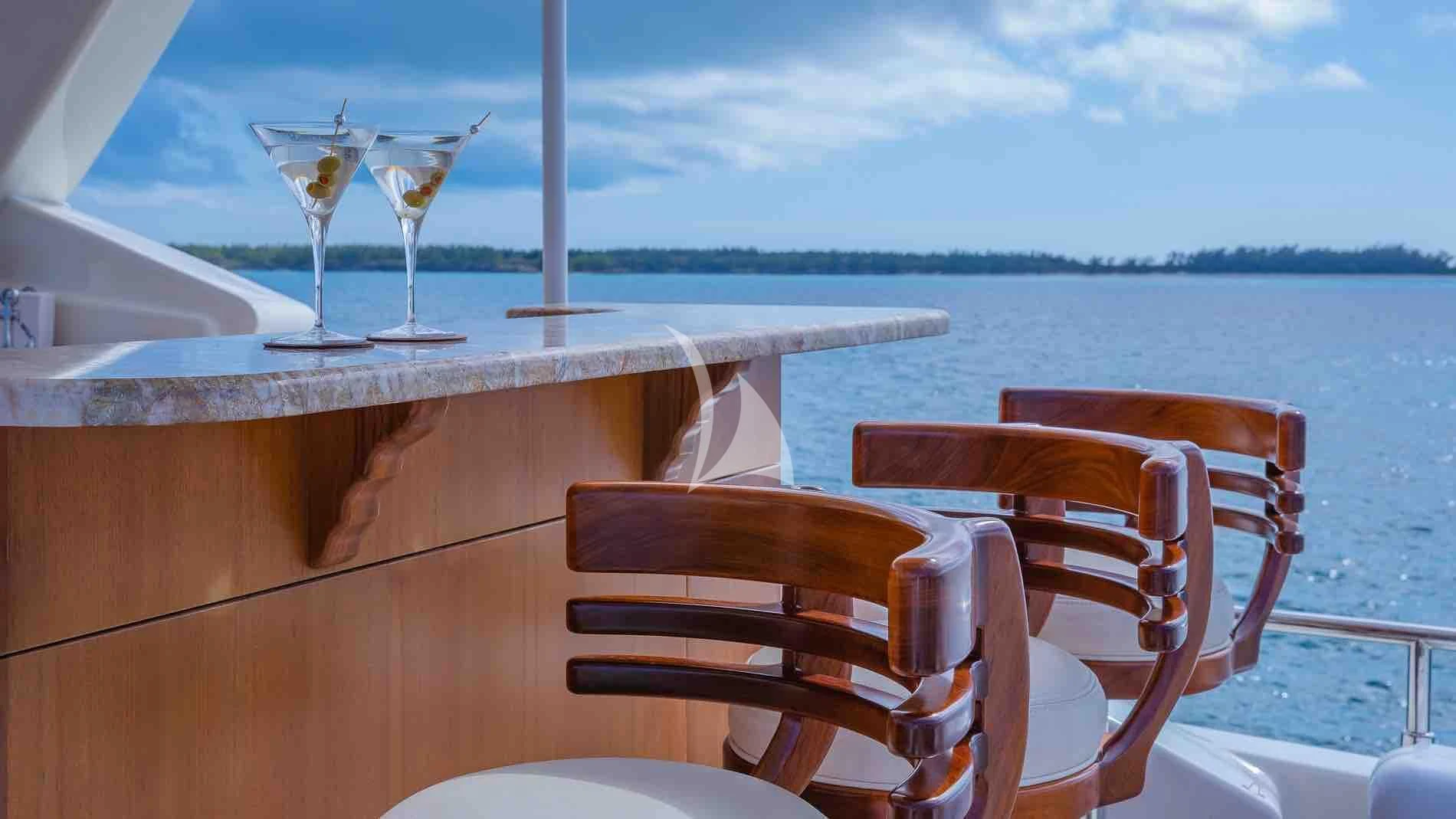 a table with wine glasses on it aboard ONE AND ONLY Yacht for Sale