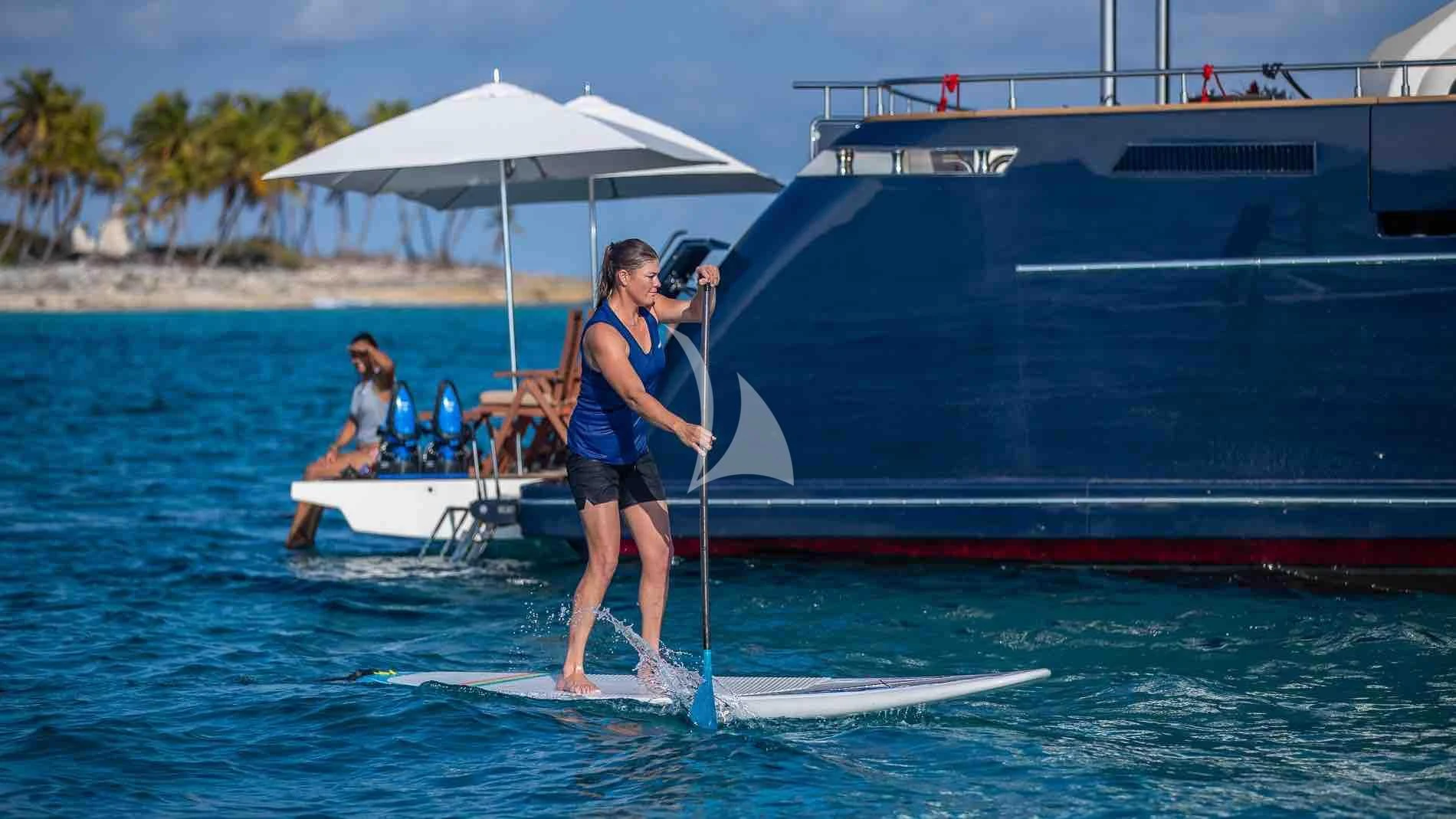 a person on a surfboard with a camera on the back aboard ONE AND ONLY Yacht for Sale