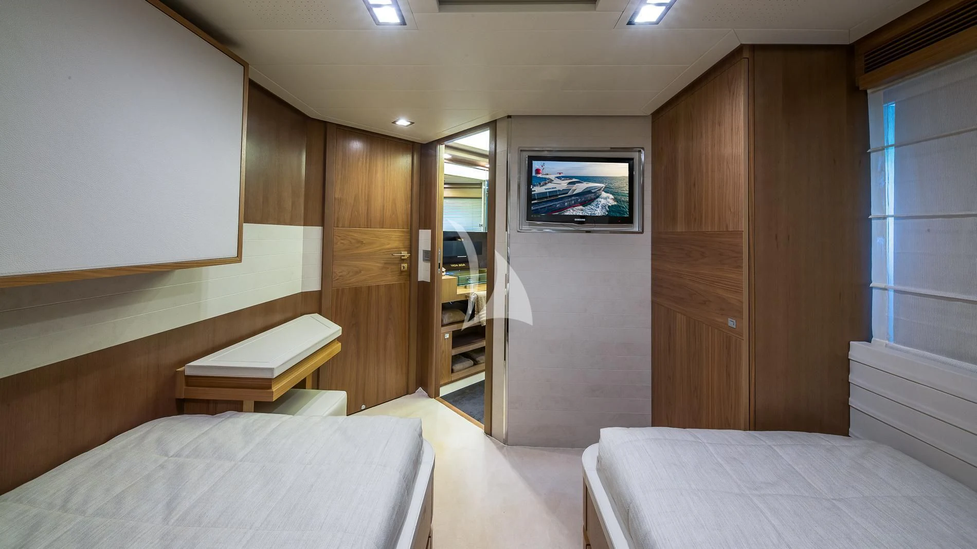 a room with a bed and a tv on the wall aboard ONE AND ONLY Yacht for Sale
