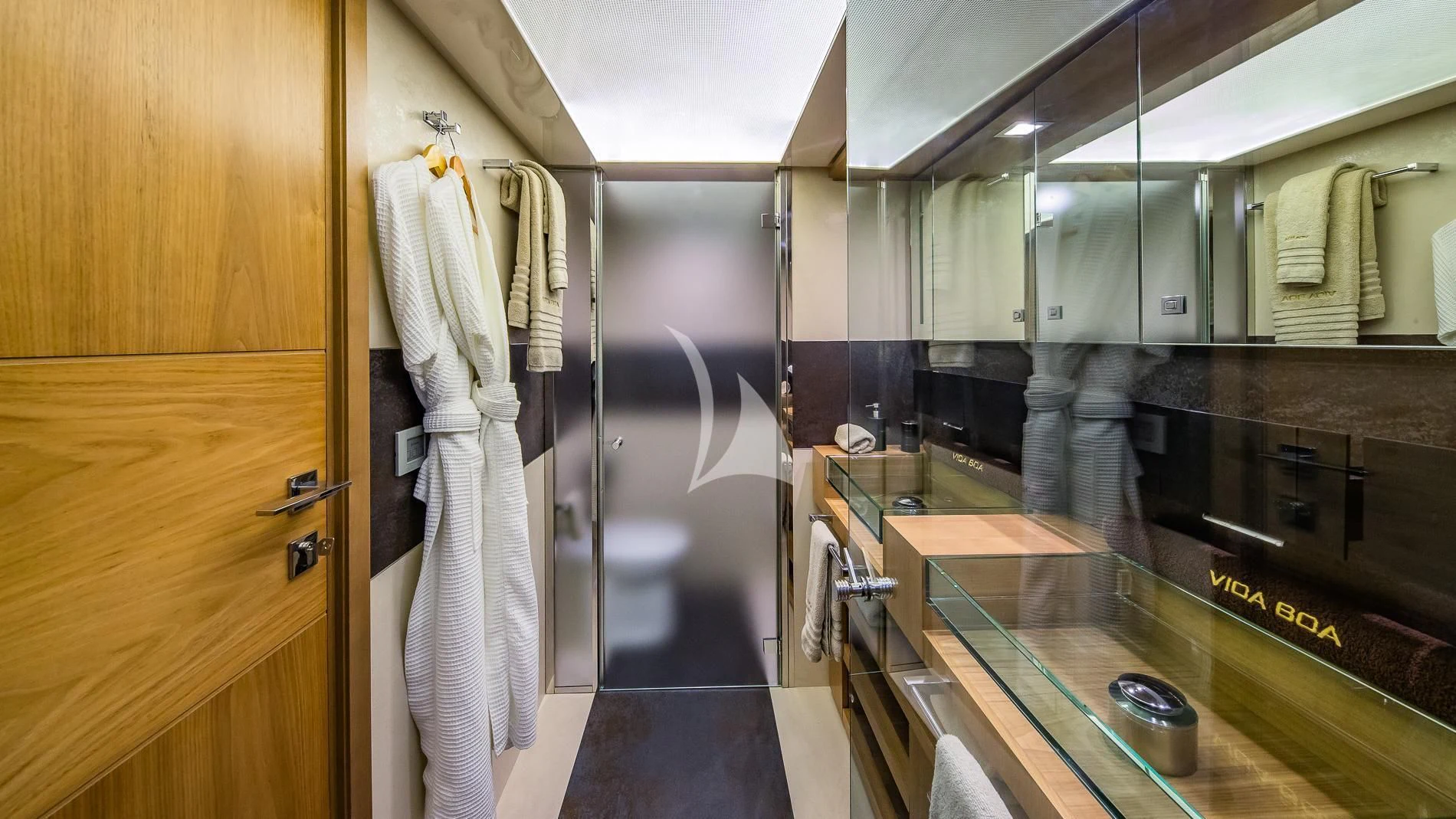 a bathroom with a robe on the wall aboard ONE AND ONLY Yacht for Sale