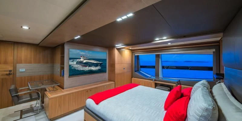 a room with a bed and a tv aboard ONE AND ONLY Yacht for Sale