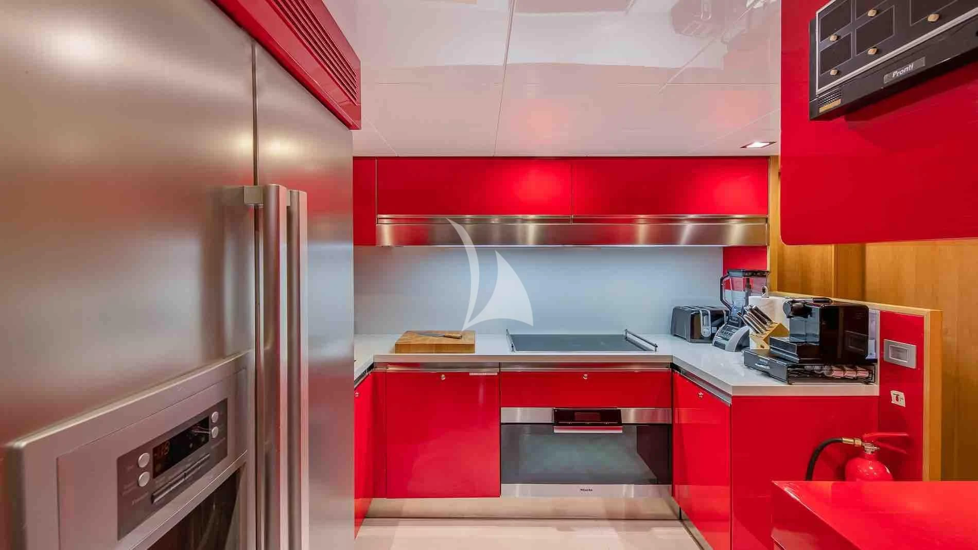 a kitchen with red cabinets aboard ONE AND ONLY Yacht for Sale