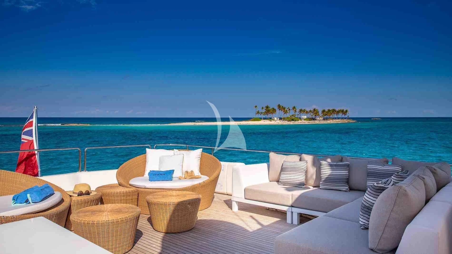a lounge area with chairs and a beach and a large body of water aboard ONE AND ONLY Yacht for Sale