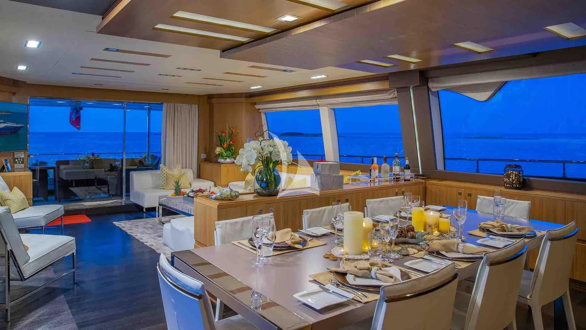 a room with tables and chairs aboard ONE AND ONLY Yacht for Sale