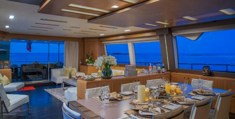 a large room with a table and chairs aboard ONE AND ONLY Yacht for Sale