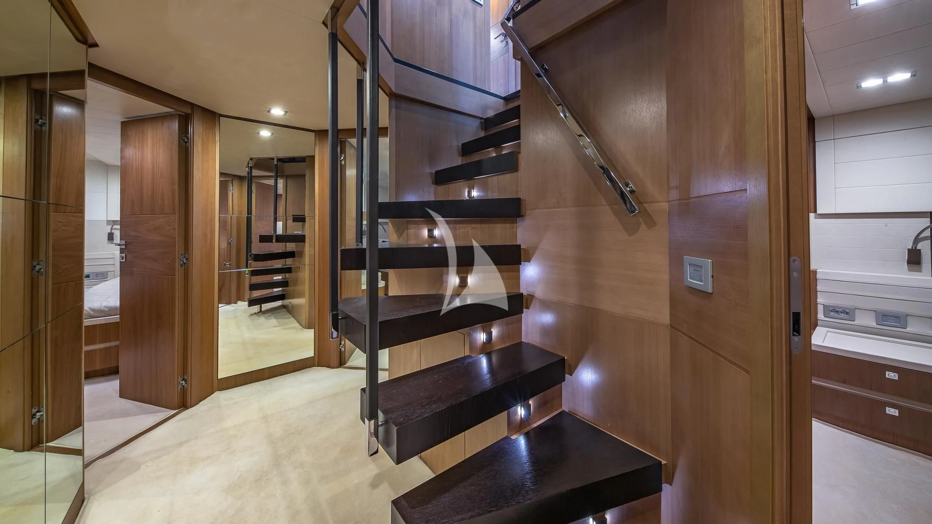 a large room with a table and stairs aboard ONE AND ONLY Yacht for Sale