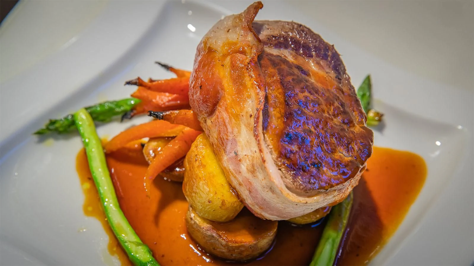 a roasted fish on a plate aboard ONE AND ONLY Yacht for Sale