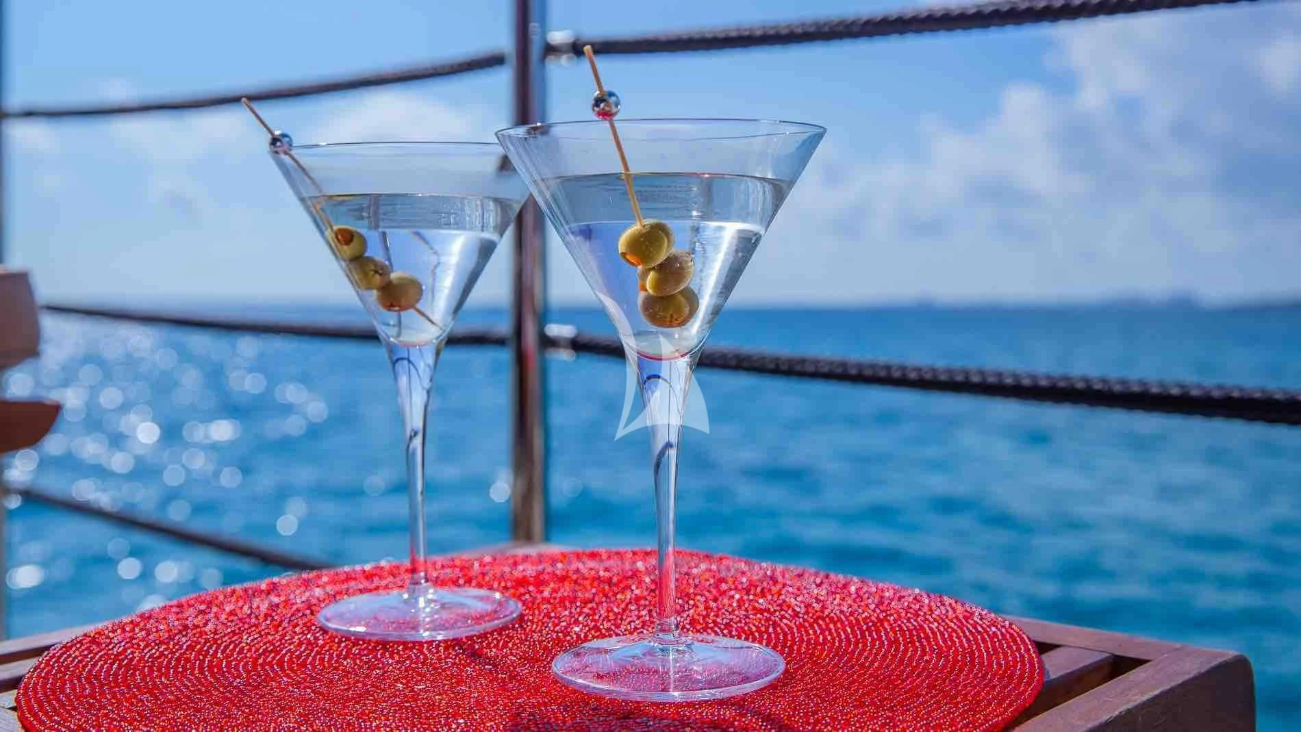 a couple of martini glasses with yellow liquid in them aboard ONE AND ONLY Yacht for Sale
