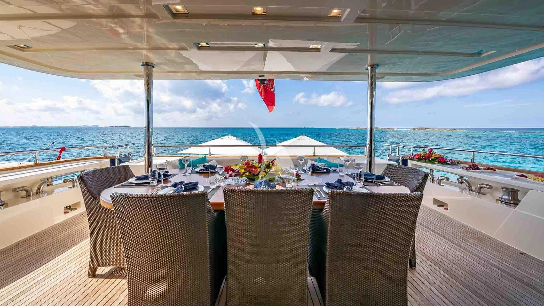 a table on a deck overlooking the ocean aboard ONE AND ONLY Yacht for Sale
