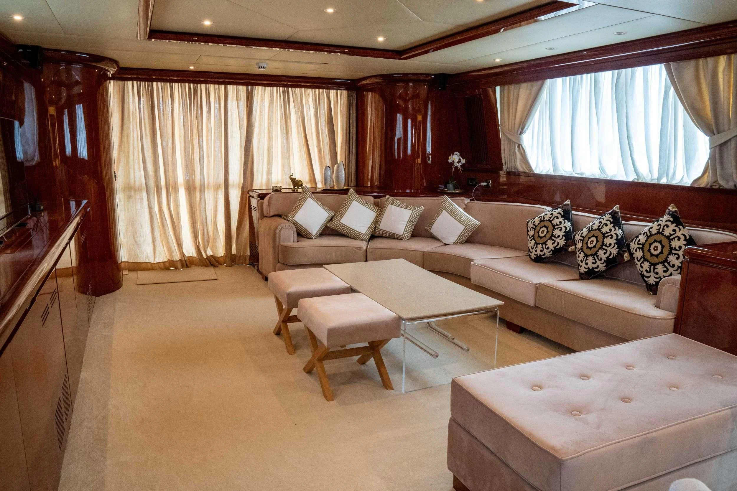 a living room with a couch and a table aboard FALCON ISLAND Yacht for Sale