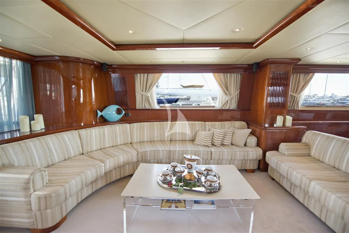 a living room with a couch and a table aboard FALCON ISLAND Yacht for Sale