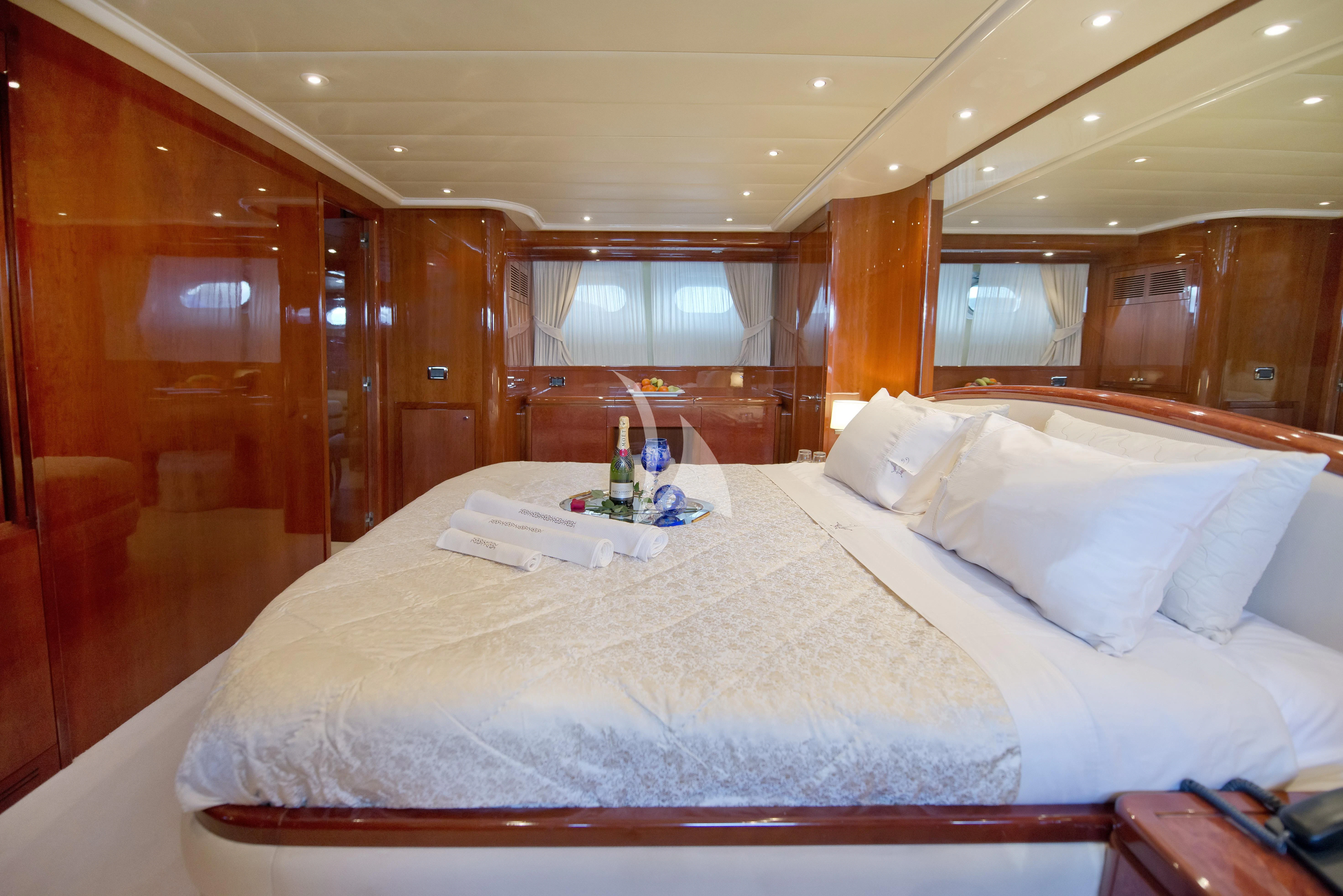 a bed with white sheets aboard FALCON ISLAND Yacht for Sale