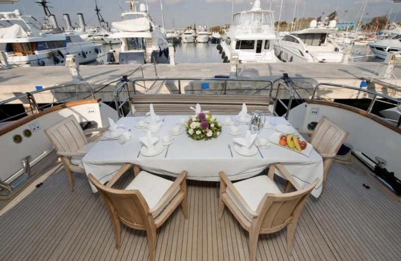 a table with flowers on it aboard FALCON ISLAND Yacht for Sale