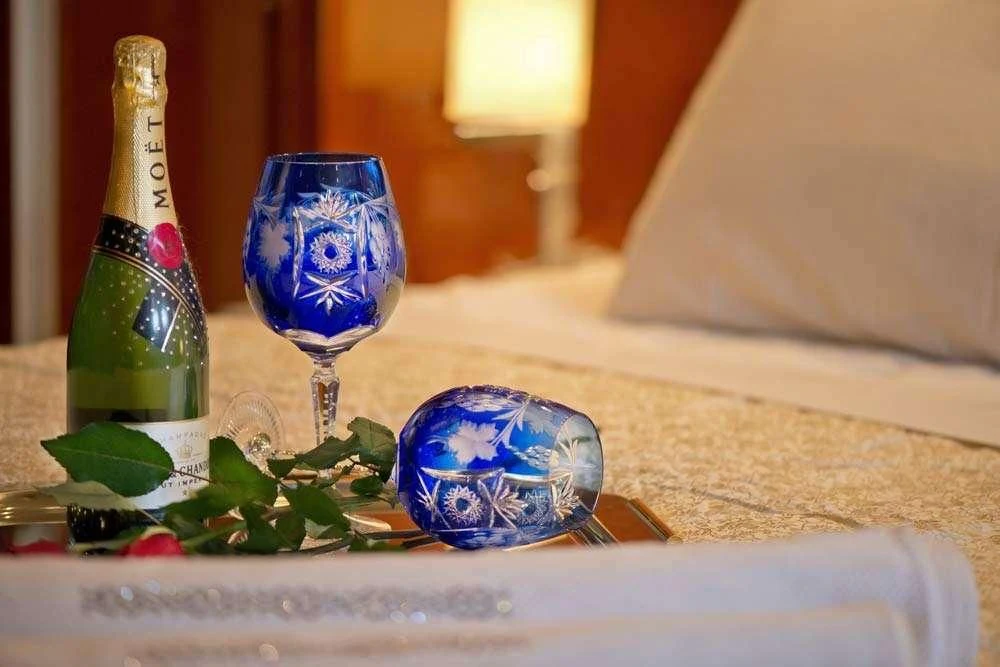 a glass and a bottle on a table aboard FALCON ISLAND Yacht for Sale
