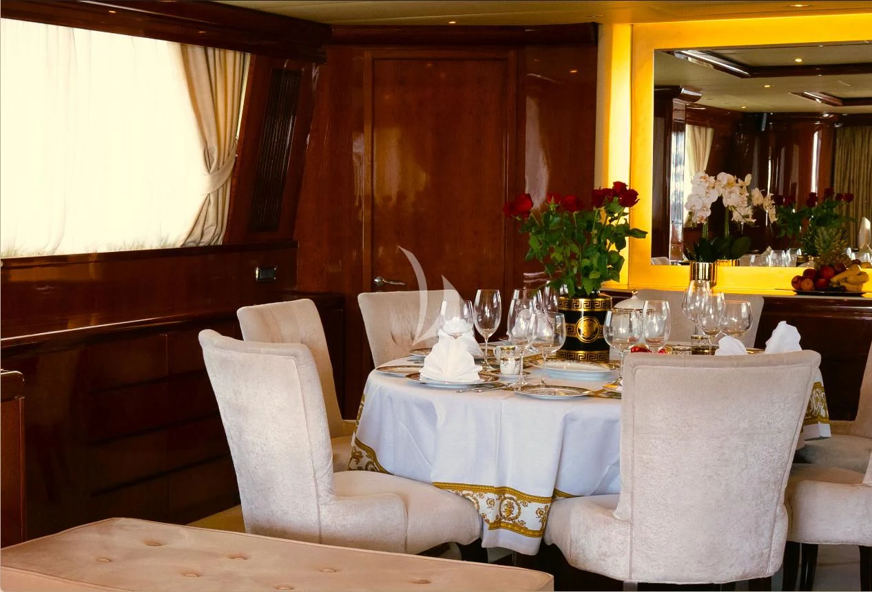 a table set with wine glasses aboard FALCON ISLAND Yacht for Sale