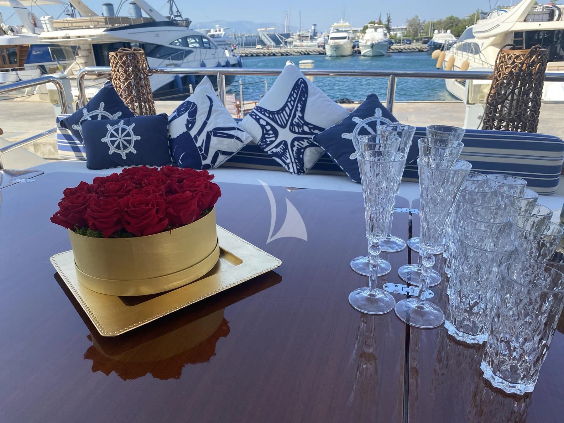 a table with glasses and flowers aboard FALCON ISLAND Yacht for Sale