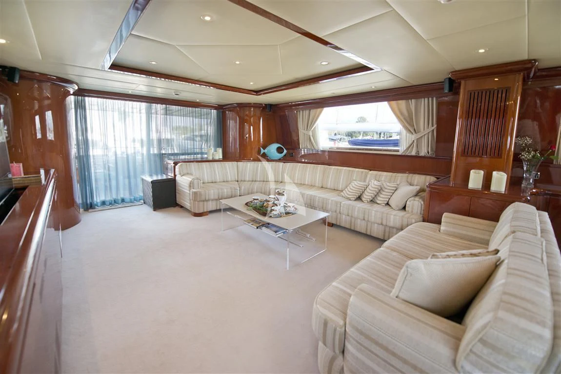 a living room with a couch and a table aboard FALCON ISLAND Yacht for Sale