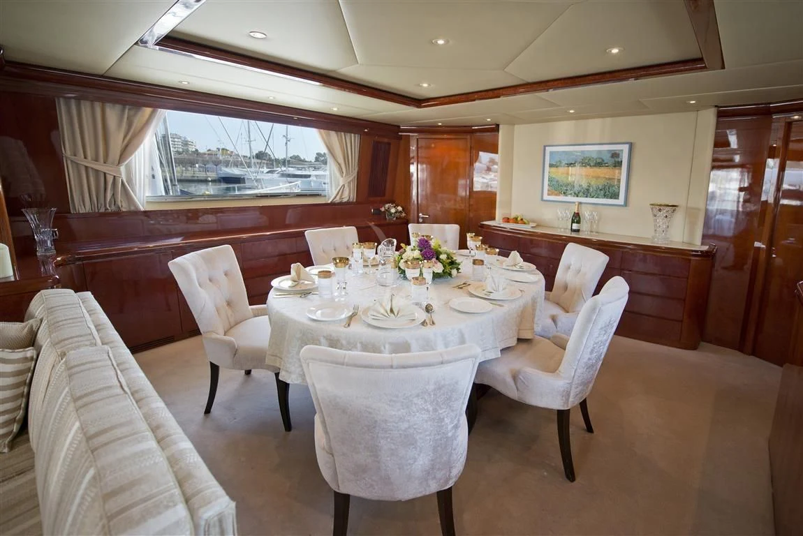 a dining room with tables and chairs aboard FALCON ISLAND Yacht for Sale