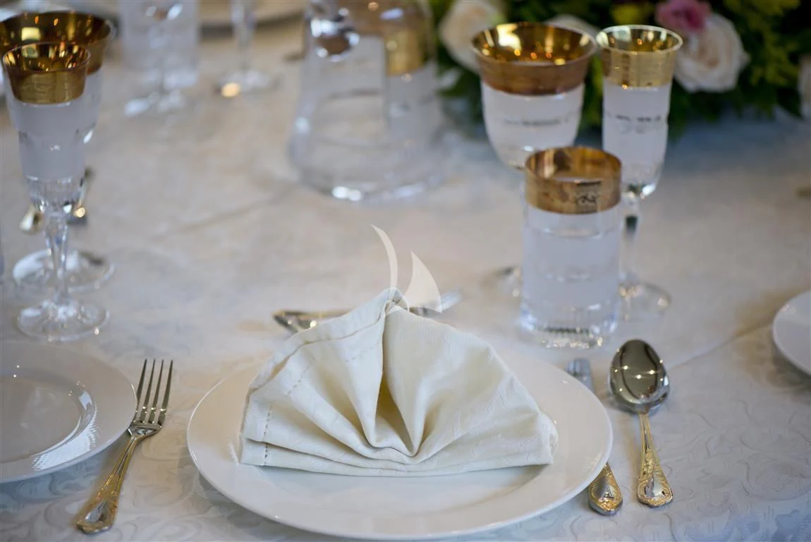 a table with plates and glasses aboard FALCON ISLAND Yacht for Sale