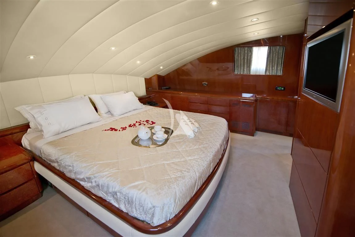 a bed with a tray of food on it aboard FALCON ISLAND Yacht for Sale