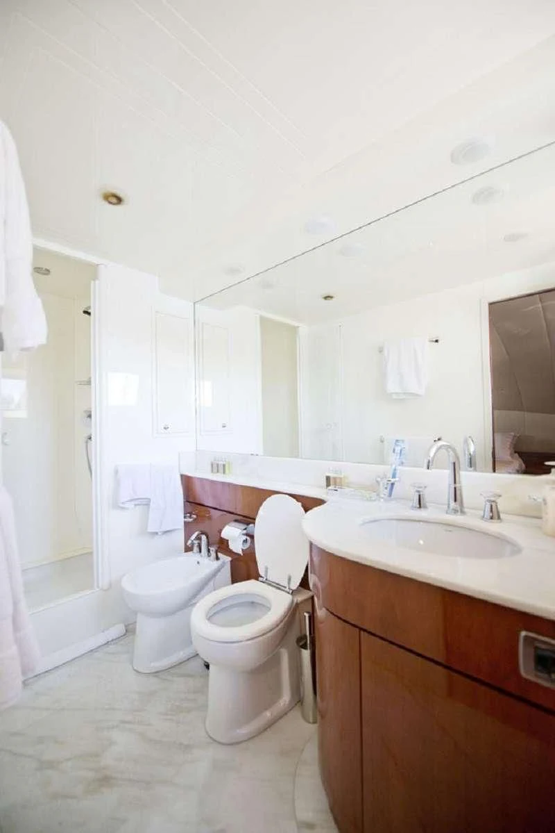 a bathroom with a toilet sink and a mirror aboard FALCON ISLAND Yacht for Sale