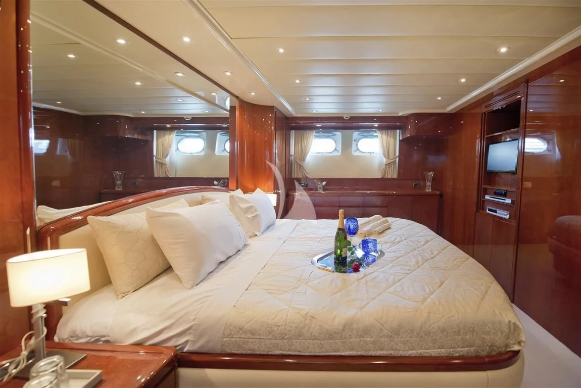 a bed with a white sheet and pillows aboard FALCON ISLAND Yacht for Sale