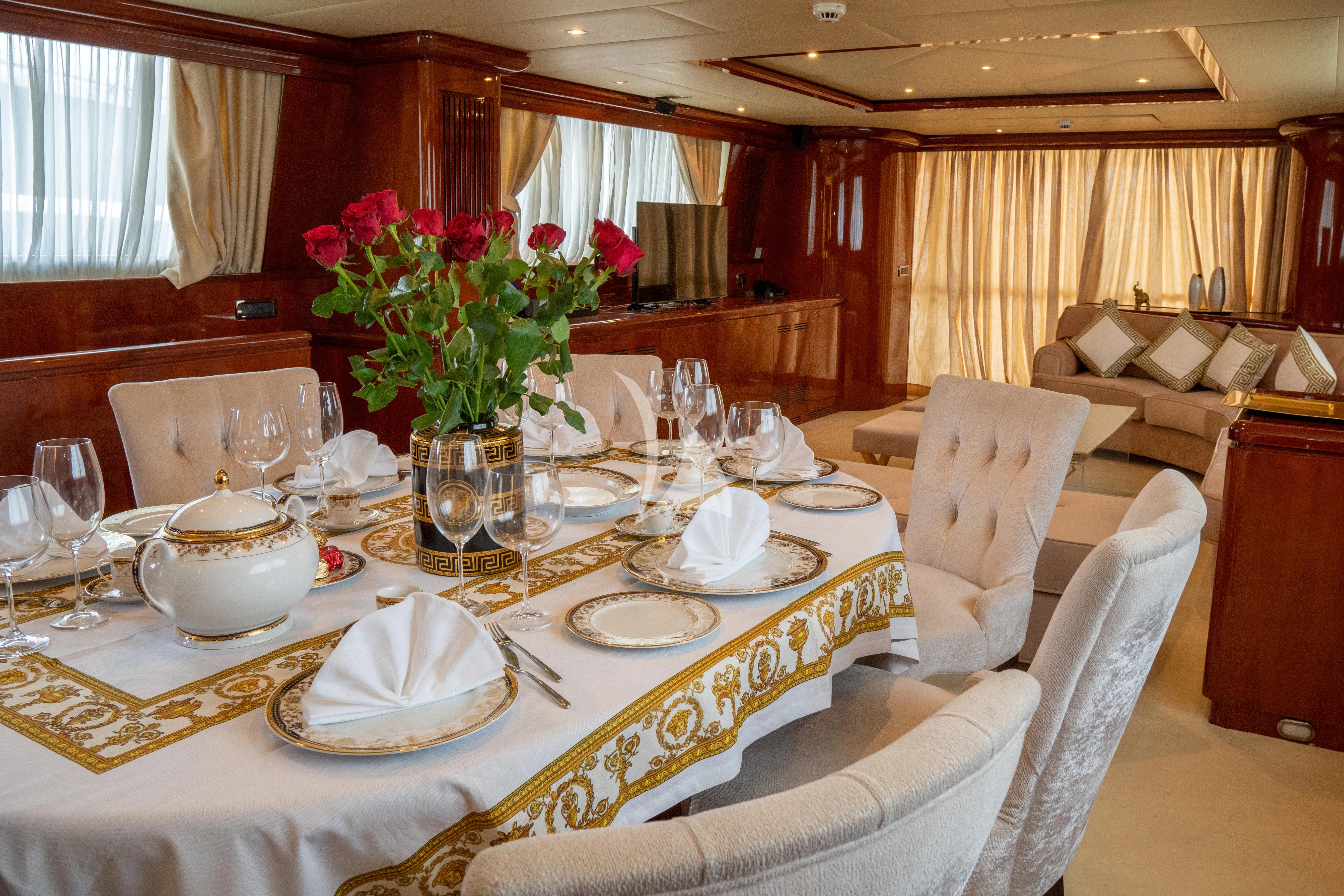 a dining room with a table set aboard FALCON ISLAND Yacht for Sale