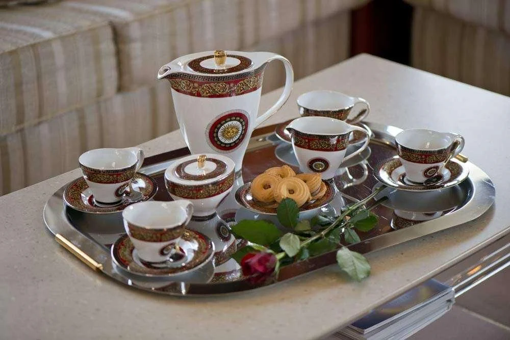 a tray of tea cups and saucers on a table aboard FALCON ISLAND Yacht for Sale