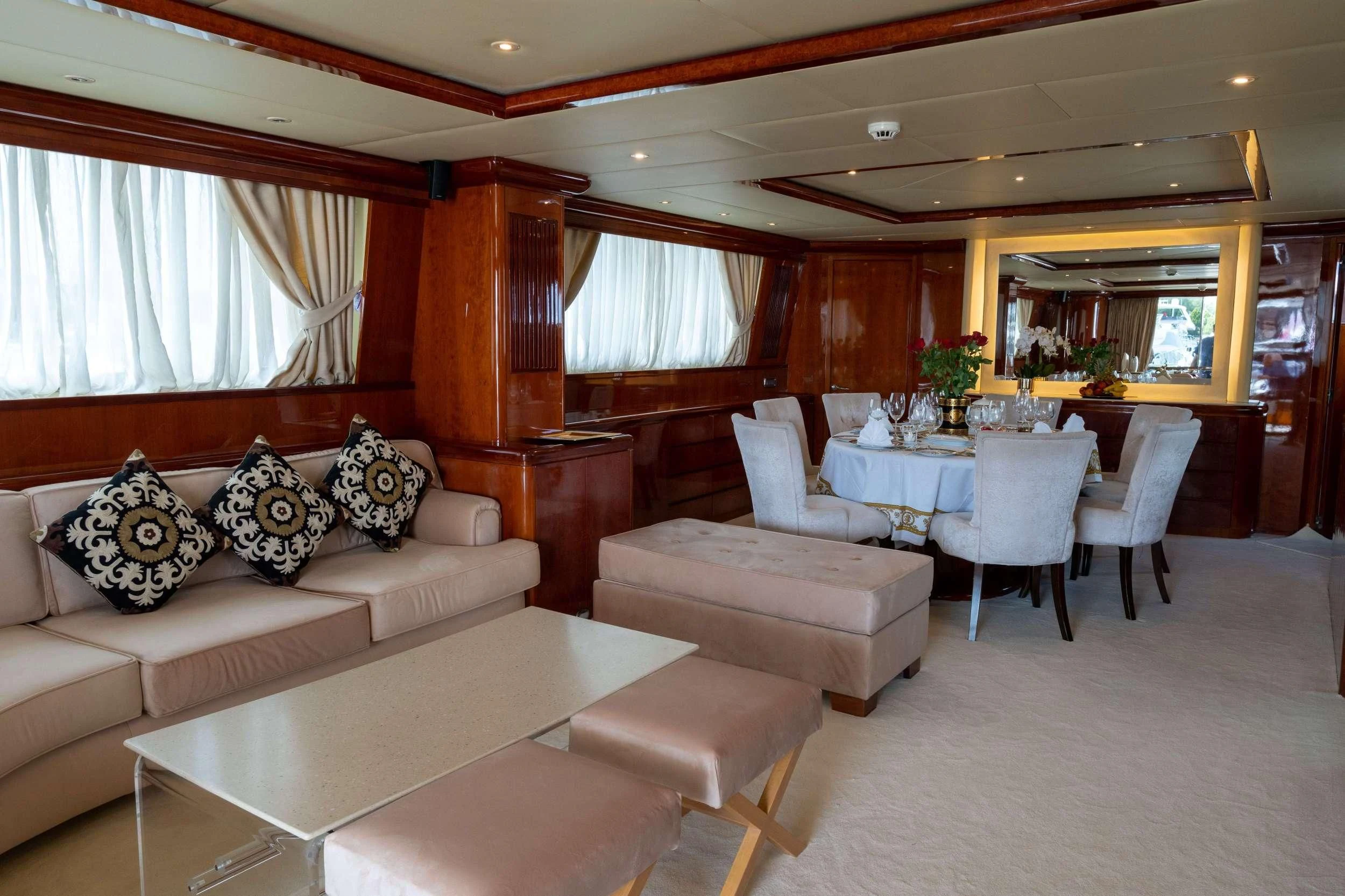 a living room with a couch and a table aboard FALCON ISLAND Yacht for Sale
