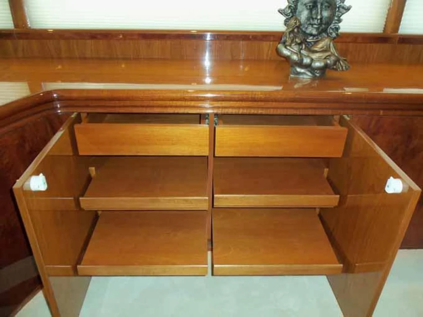 a wooden shelf with a statue on it aboard DOLCE VITA Yacht for Sale