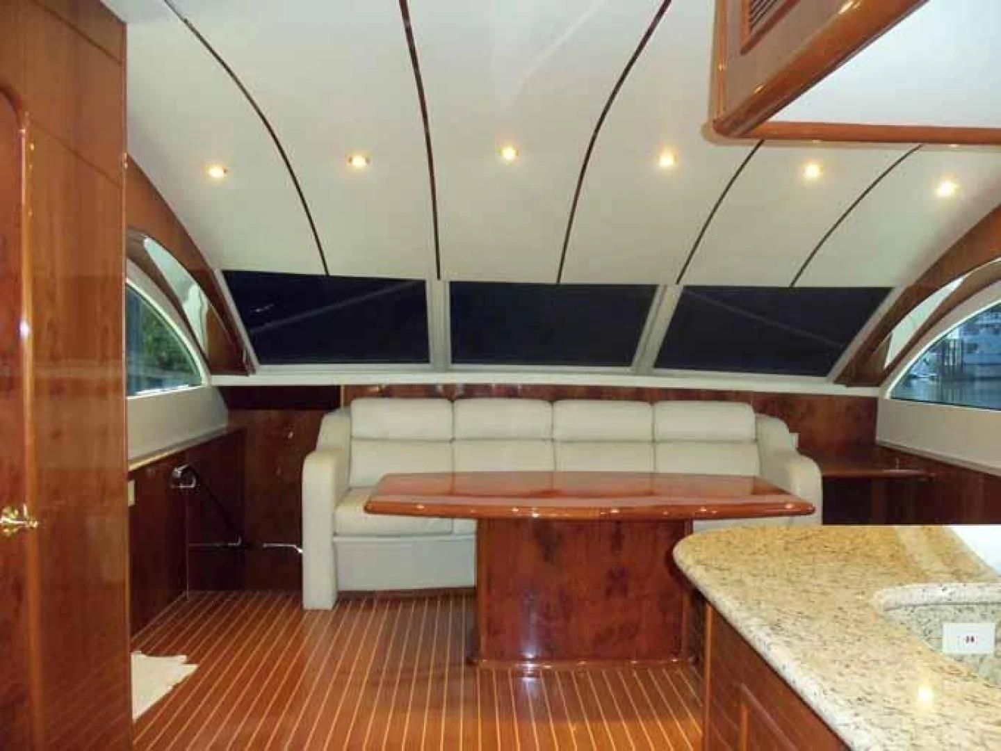 a room with a table and a bench aboard DOLCE VITA Yacht for Sale