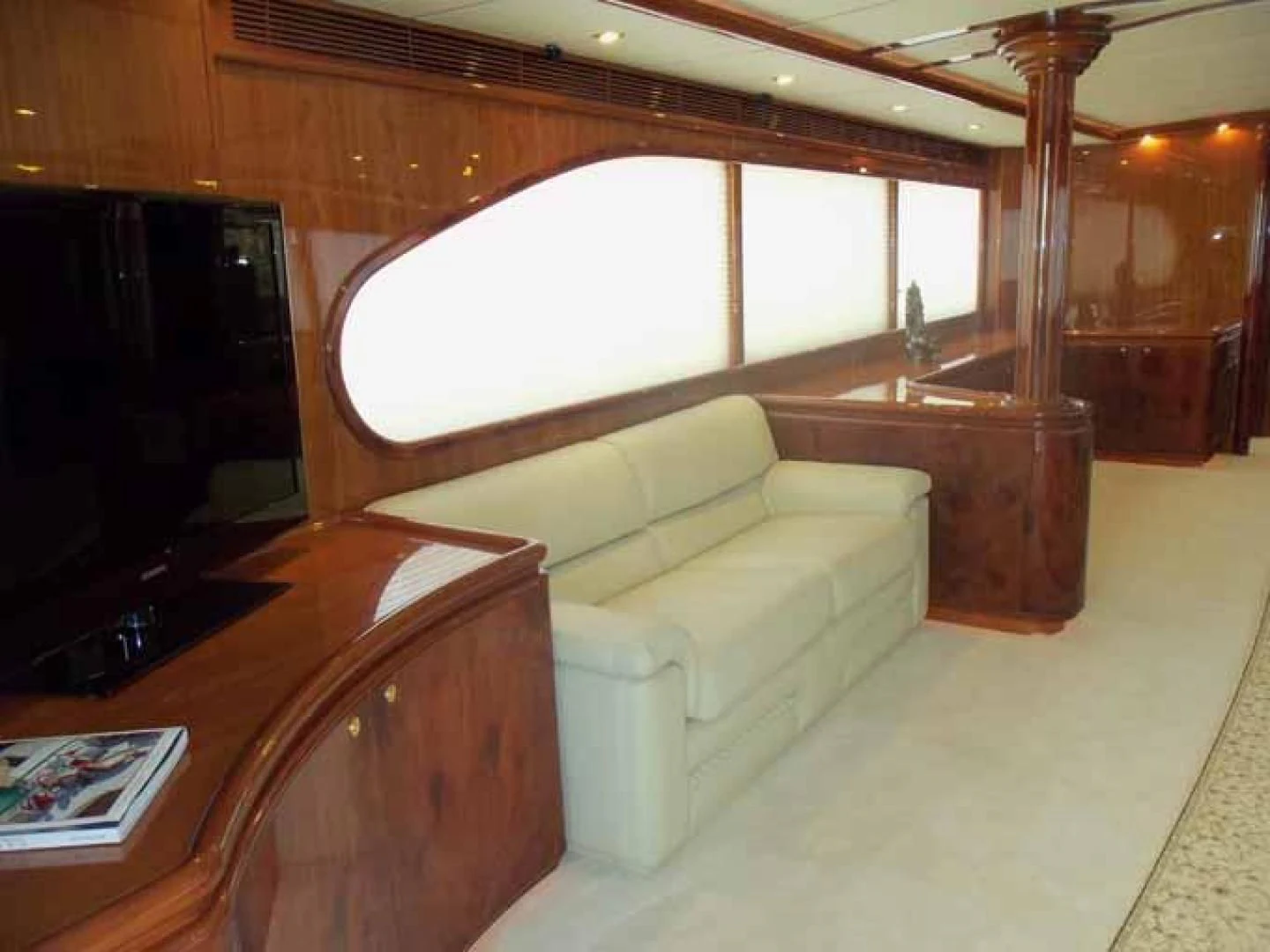 a living room with a couch and a tv aboard DOLCE VITA Yacht for Sale