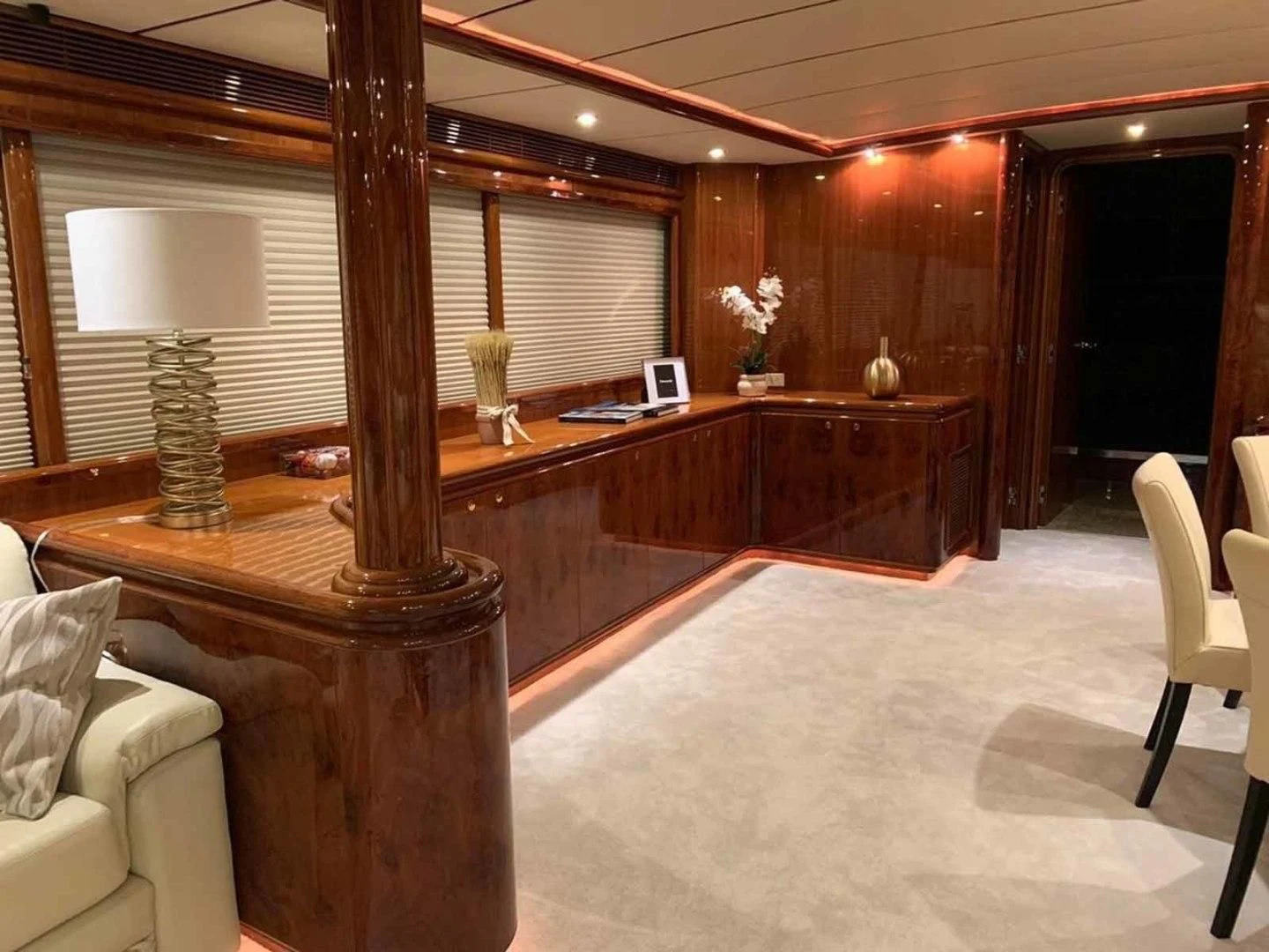 a room with a wood desk and a large window aboard DOLCE VITA Yacht for Sale