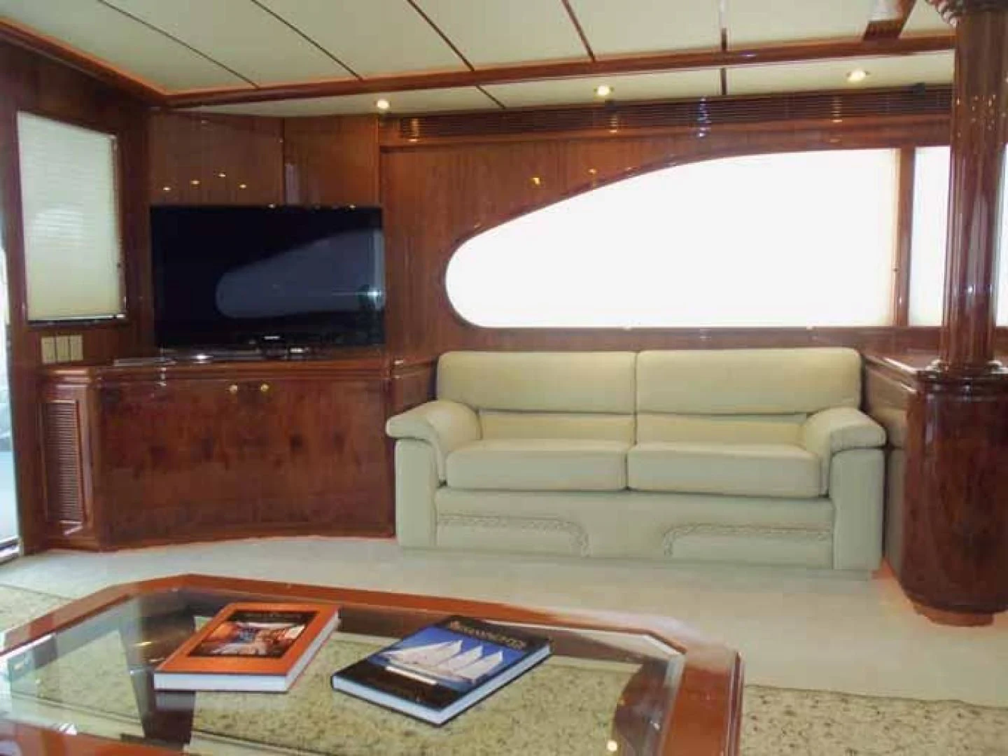 a living room with a couch and a tv aboard DOLCE VITA Yacht for Sale