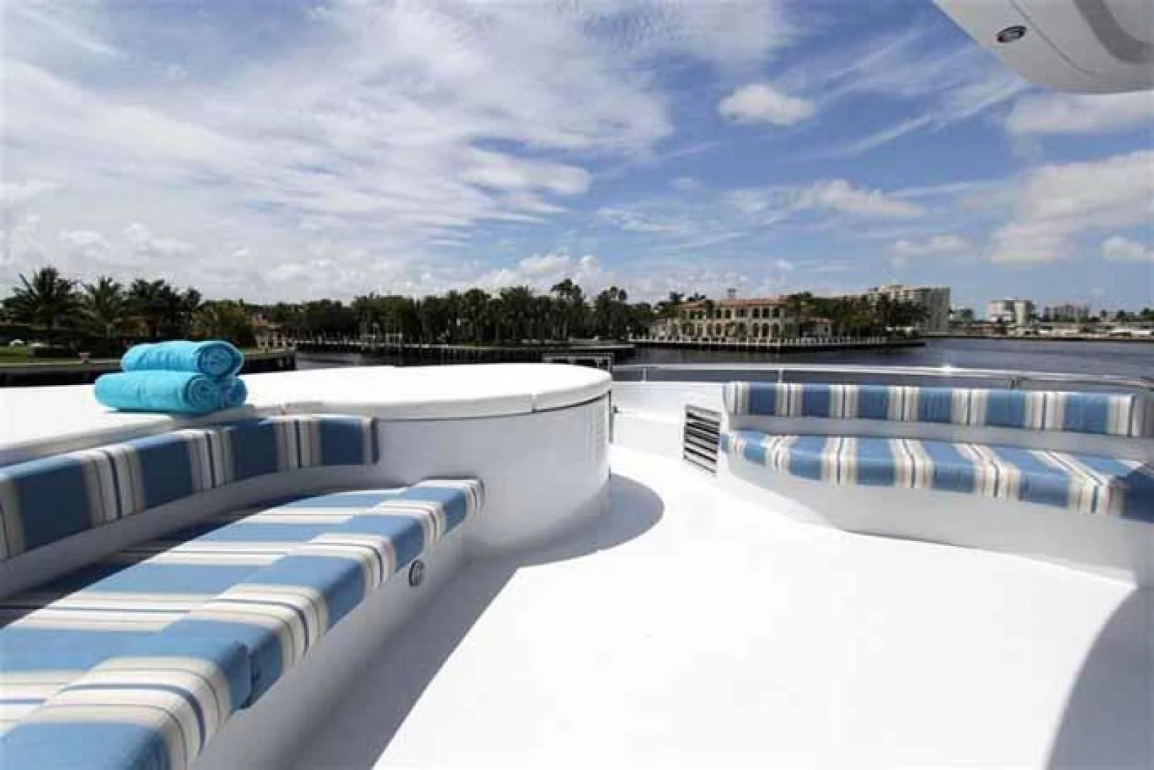 a pool with a view of a city and trees aboard DOLCE VITA Yacht for Sale