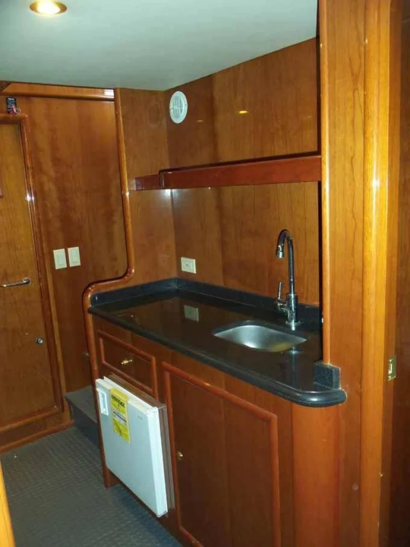a kitchen with wooden cabinets aboard DOLCE VITA Yacht for Sale