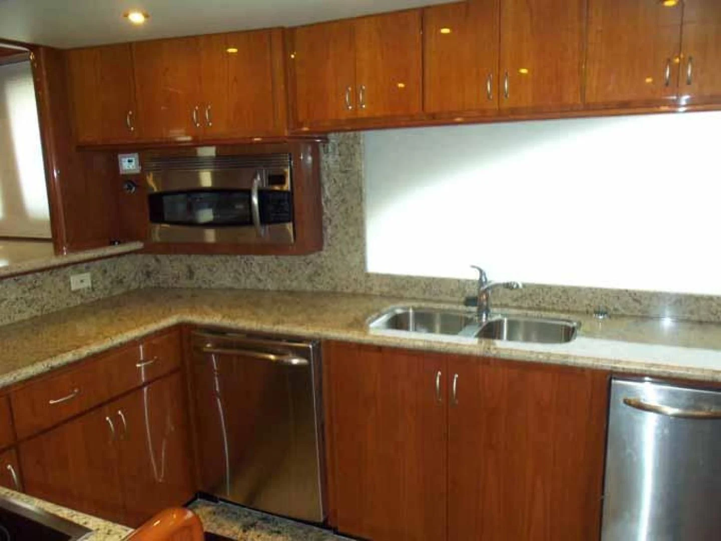 a kitchen with wooden cabinets aboard DOLCE VITA Yacht for Sale