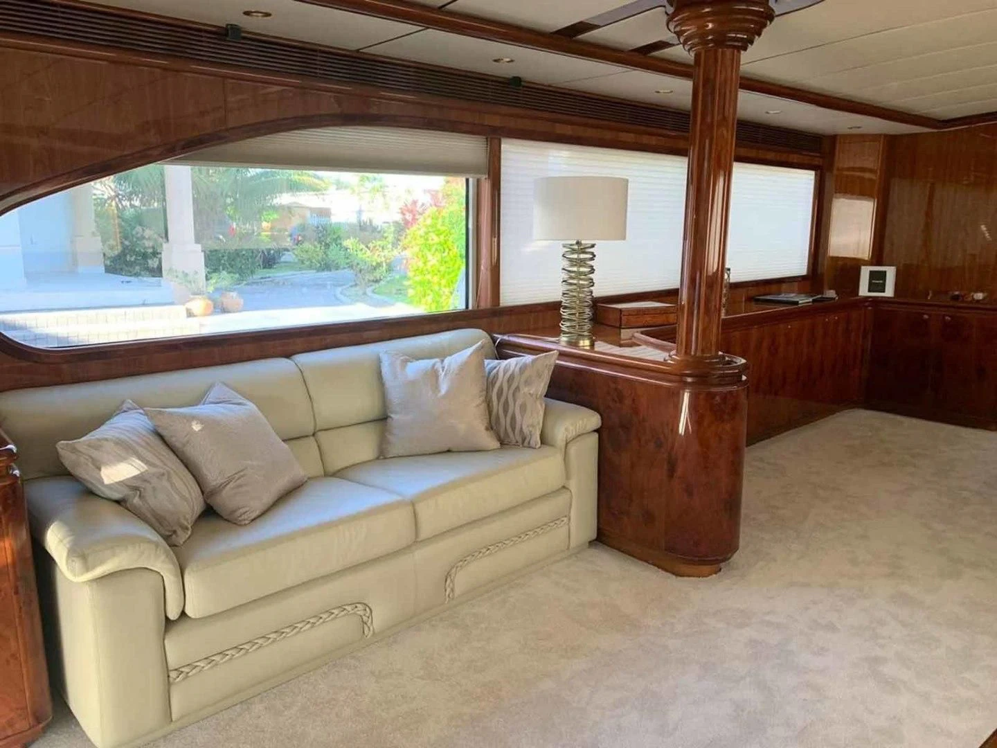 a living room with a large wood bed and a large window aboard DOLCE VITA Yacht for Sale
