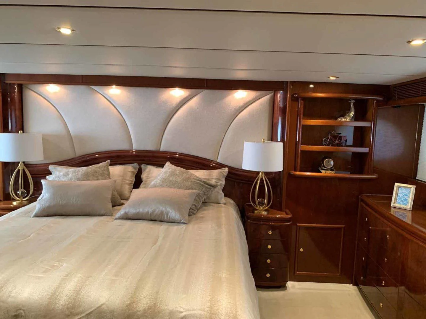 a bed with a white comforter aboard DOLCE VITA Yacht for Sale