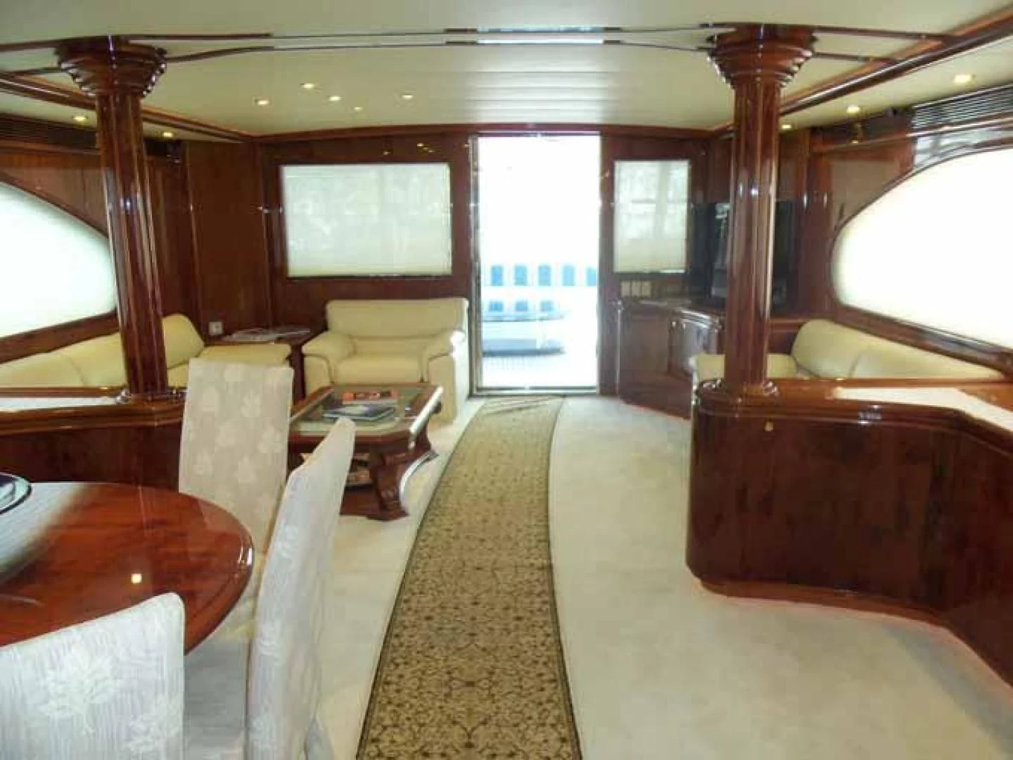 a room with a bed and a table aboard DOLCE VITA Yacht for Sale