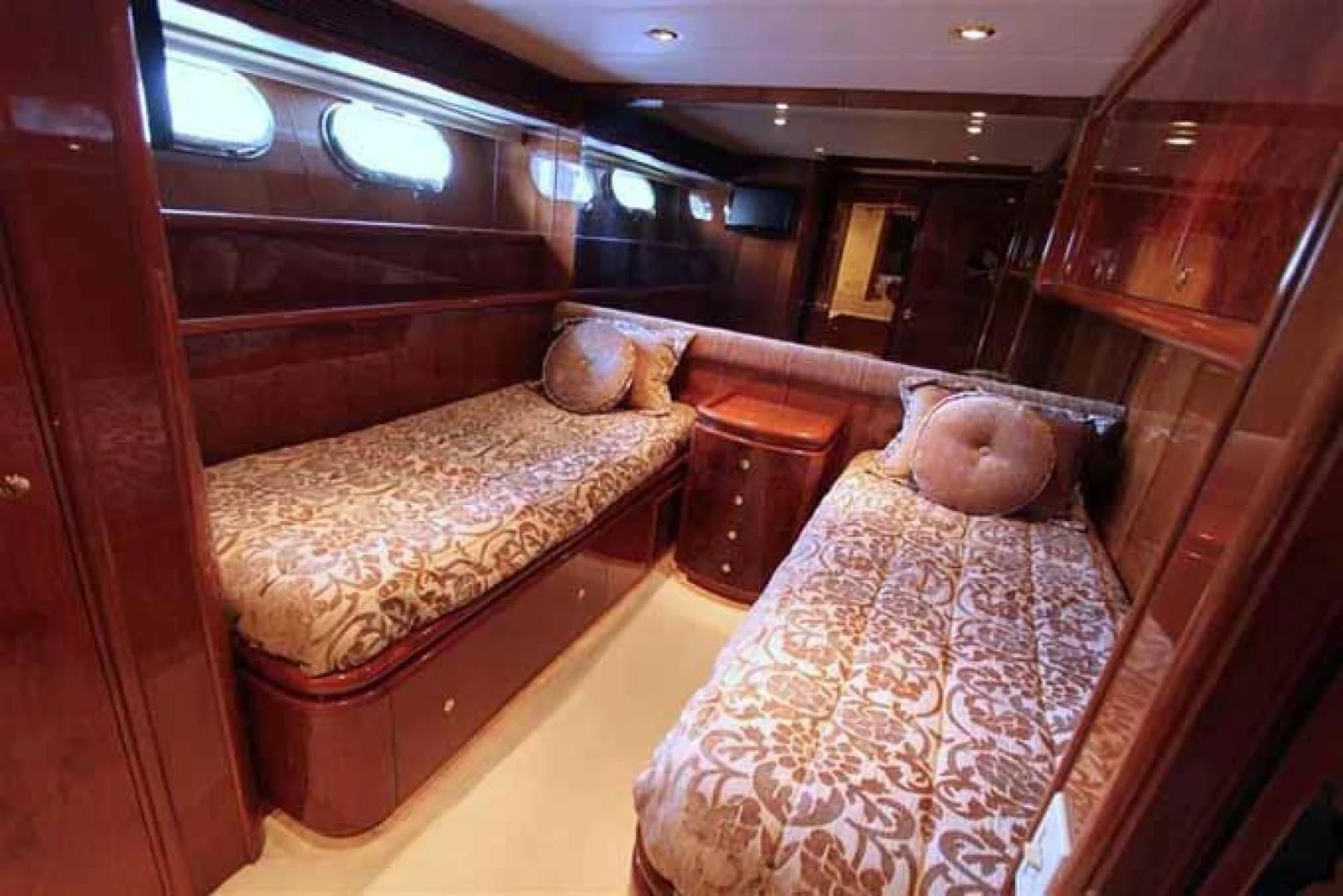 a room with a bed and a chair aboard DOLCE VITA Yacht for Sale