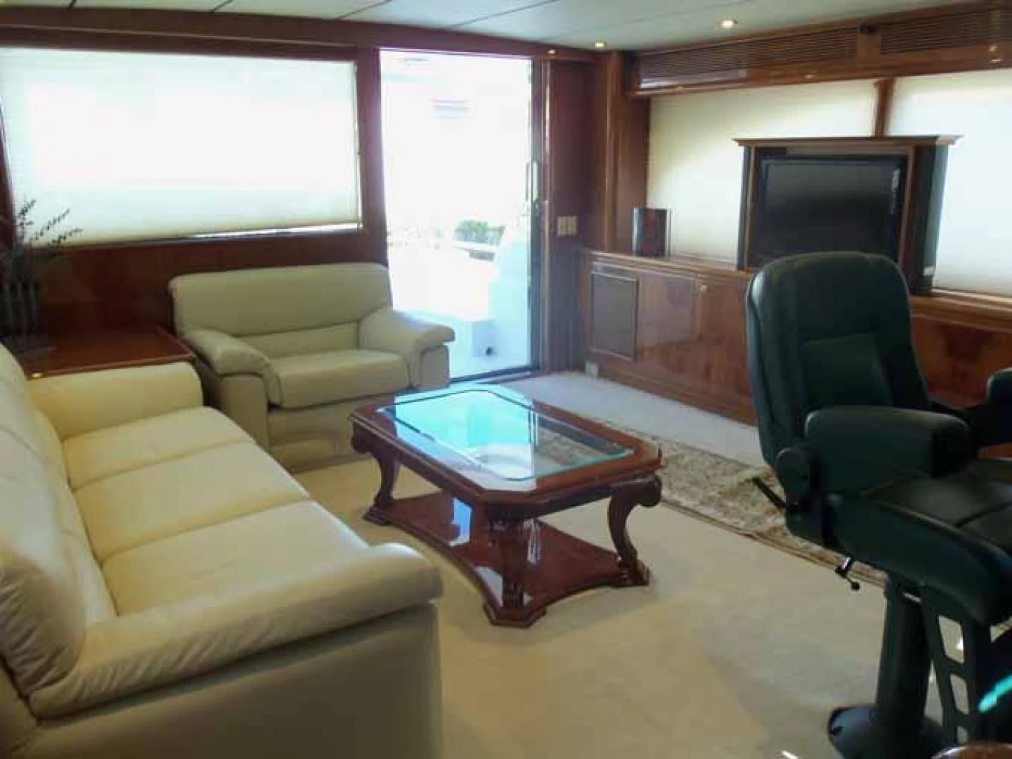 a living room with a table and chairs aboard DOLCE VITA Yacht for Sale