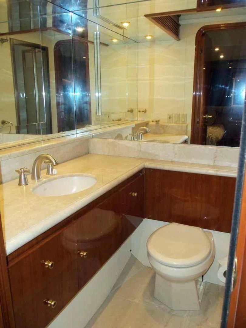 a bathroom with a toilet and a sink aboard DOLCE VITA Yacht for Sale
