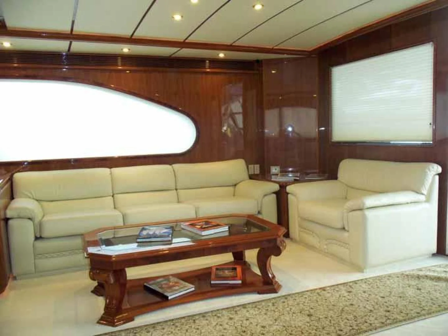 a living room with a couch and a coffee table aboard DOLCE VITA Yacht for Sale