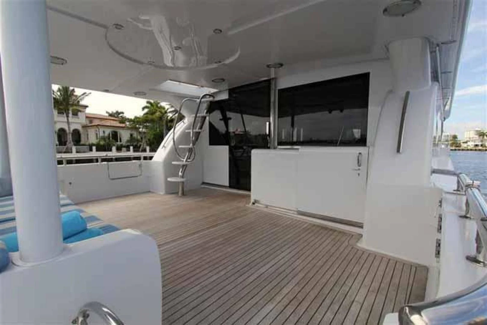 a room with a large window and a deck with a pool and a deck and a view of aboard DOLCE VITA Yacht for Sale