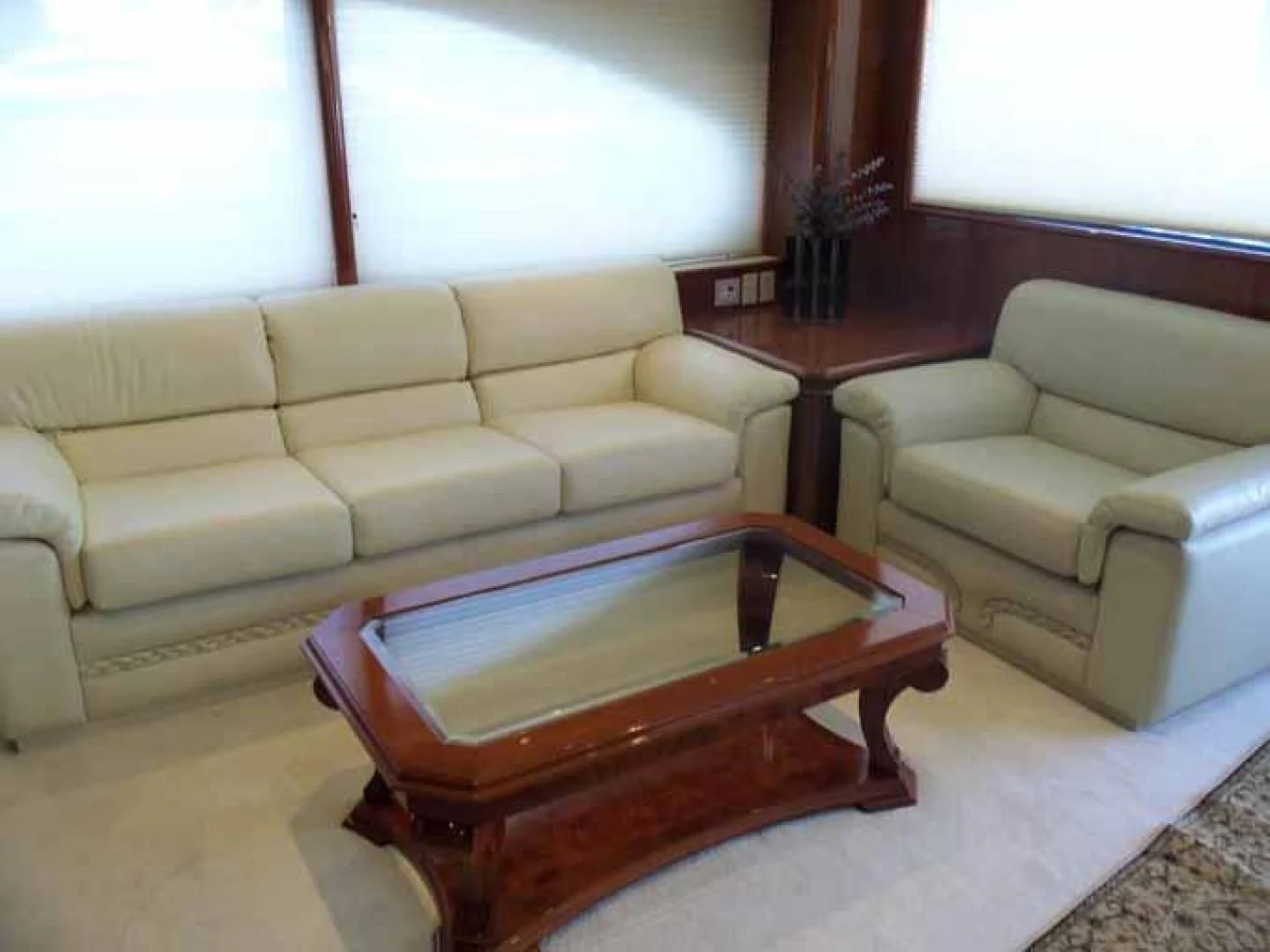 a living room with a table and couches aboard DOLCE VITA Yacht for Sale
